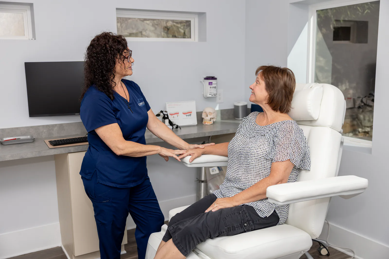 Team member comforting a patient in the treatment chair before sedation