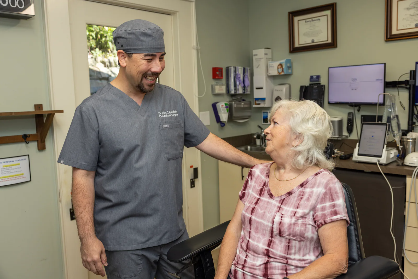 Dr. John Pritchett checking in with a patient before treatment