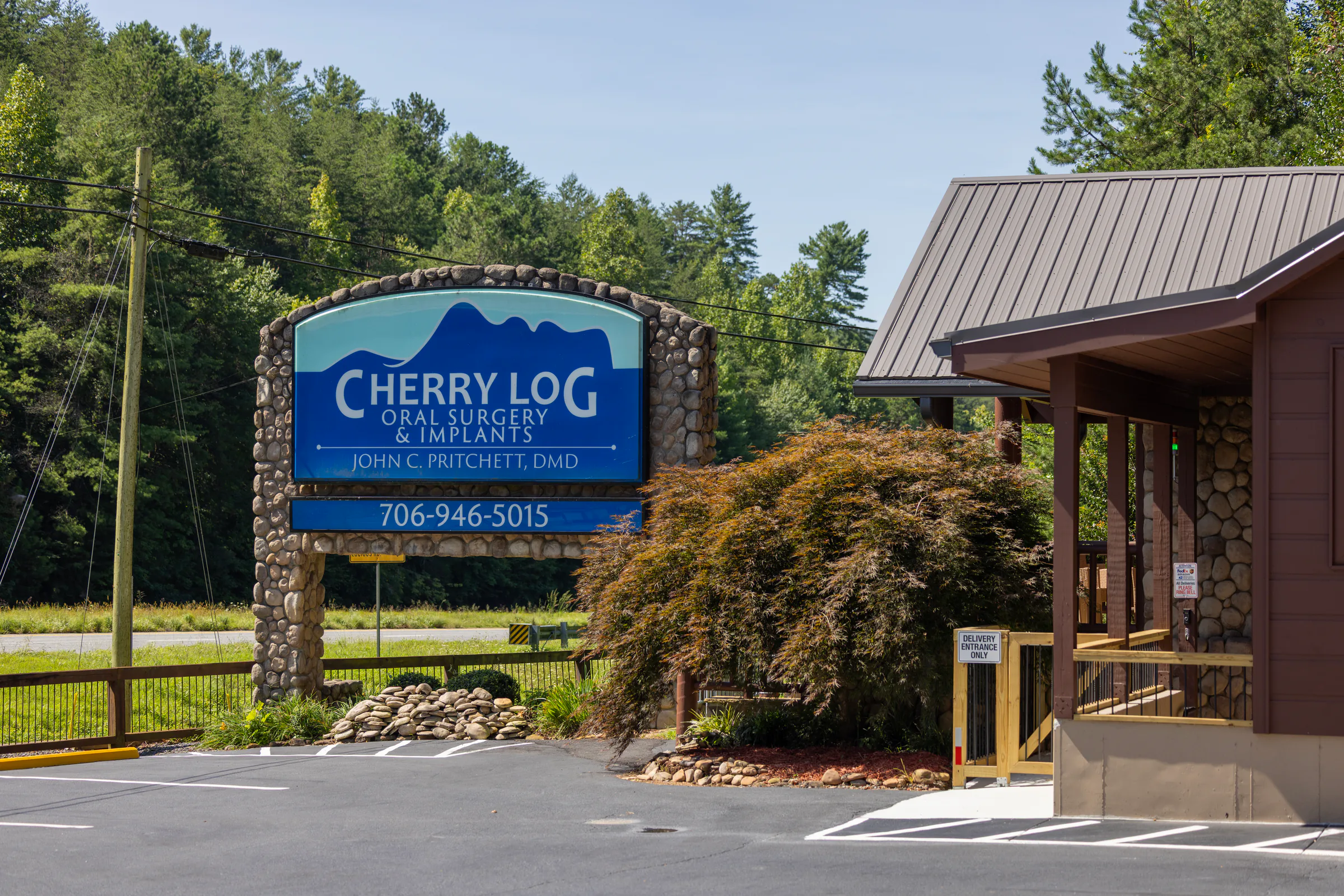 Cherry Log Oral Surgery and Implants sign outside the office