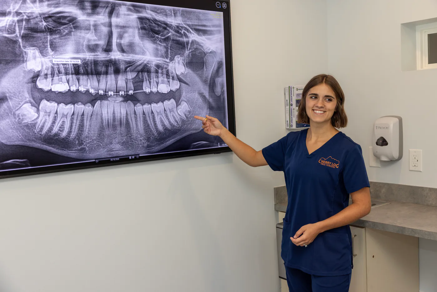 Team member explaining a panoramic X-ray